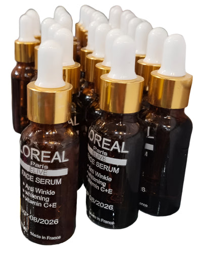L'Oreal skincare bottles on a glass counter with a blurred background